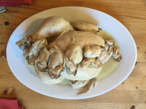 boiled chicken stuffed with oysters served with stewed oysters on top